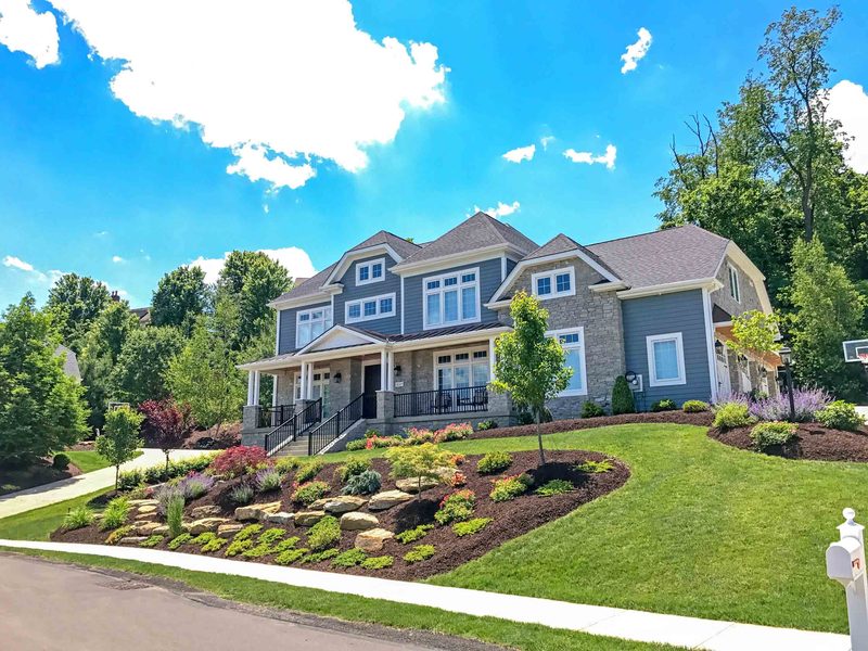 Front yard landscape installation with boulder beds and new plantings