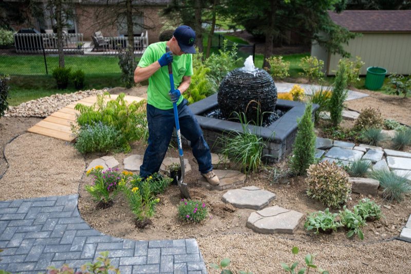Dream Greener crew member installing perennials on a South Hills property